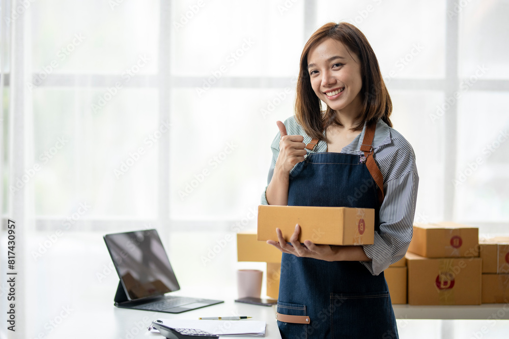 A woman is holding boxes and smiling A woman is holding boxes and smiling