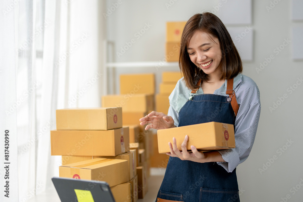 A woman is holding boxes and smiling A woman is holding boxes and smiling