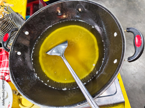 dirty cooking oil with piles of fried food residue in the pan.