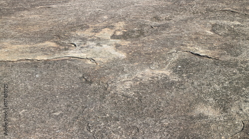 Details of sand stone texture, closeup shot of rock surface with vignette at cover and bright spot at centre, idea for background or backdrop.