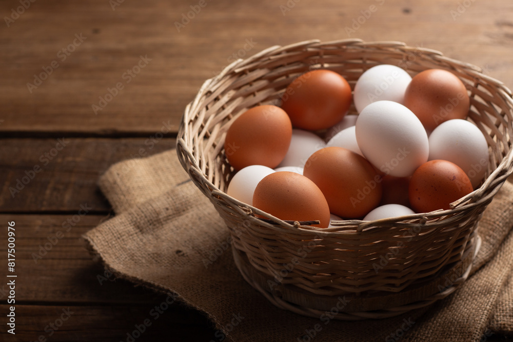 Basket of chicken eggs on a wooden table Basket of chicken eggs on a wooden table