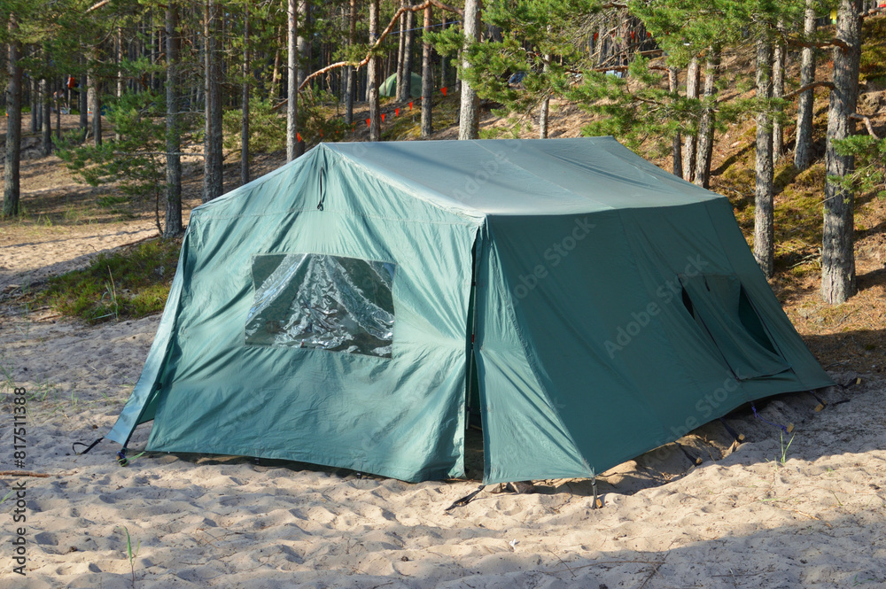 Tourist tent on sand in forest.