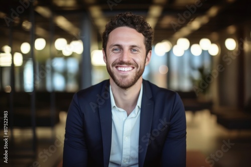 portrait of smiling businessman standing at creative office