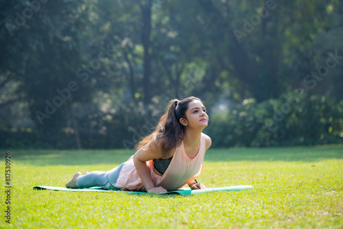Wallpaper Mural Young Pretty Woman Doing Yoga Surya Namaskar Fitness Exercise Stretching Workout in Park
 Torontodigital.ca