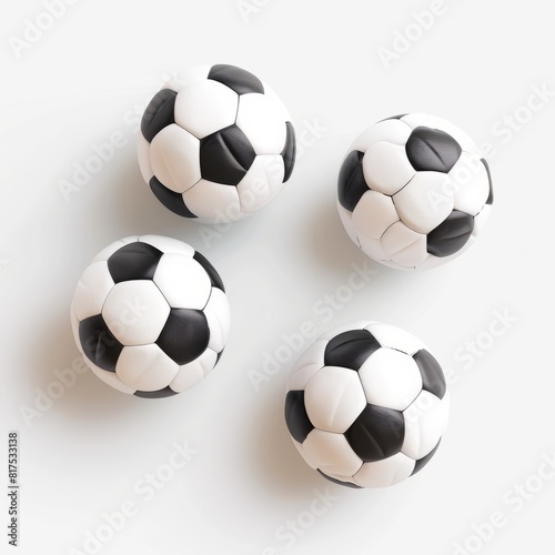 Four soccer balls arranged neatly on a white background