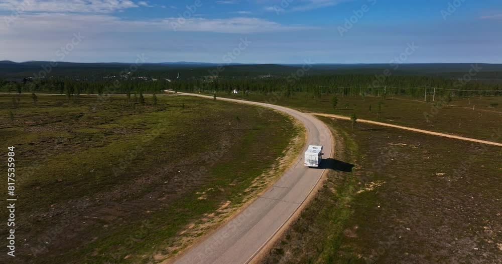 Aerial view following a RV driving down from a fell, in Inari-Saariselka, Finland Aerial view following a RV driving down from a fell, in Inari-Saariselka, Finland