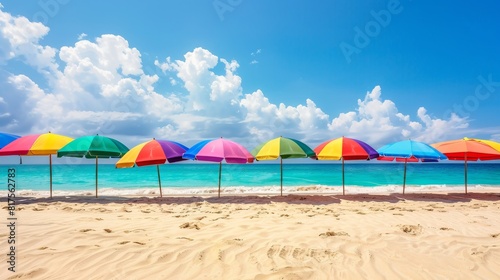Colorful beach umbrellas line the sunny beach  offering shade.