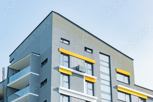 Luxurious modern apartment building in urban district, expensive rental properties. New condominiums with blue sky, community facilities. Investing in contemporary European style real estate.