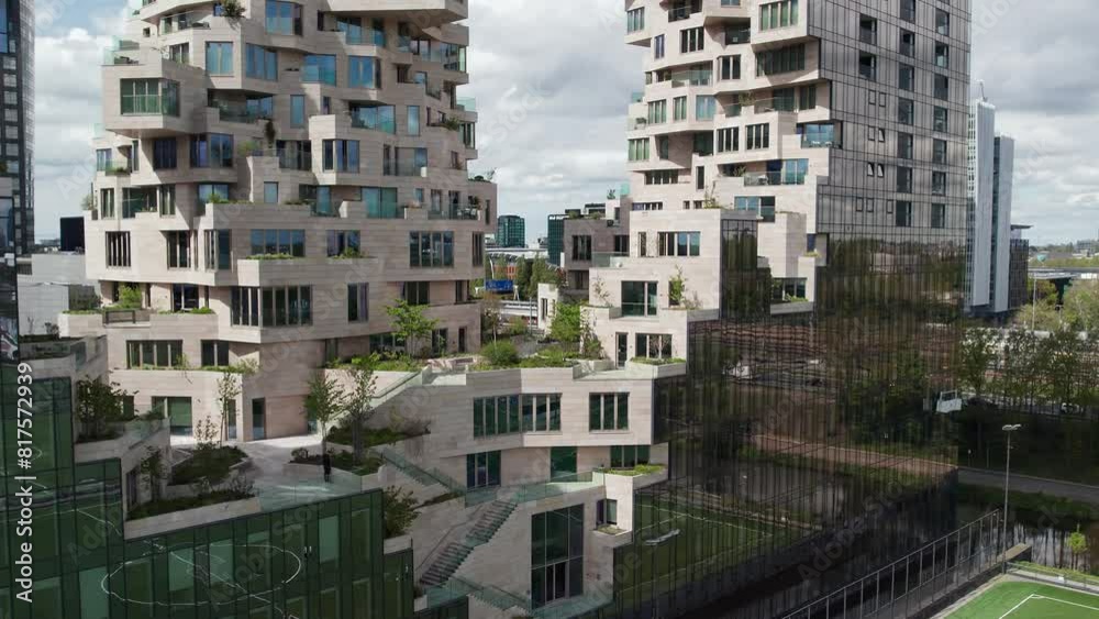 Terraced Facade Of The Valley Apartments In Amsterdam's Zuidas, Netherlands. ascending drone shot Terraced Facade Of The Valley Apartments In Amsterdam's Zuidas, Netherlands. ascending drone shot