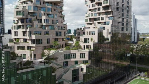 Terraced Facade Of The Valley Apartments In Amsterdam's Zuidas, Netherlands. ascending drone shot photo