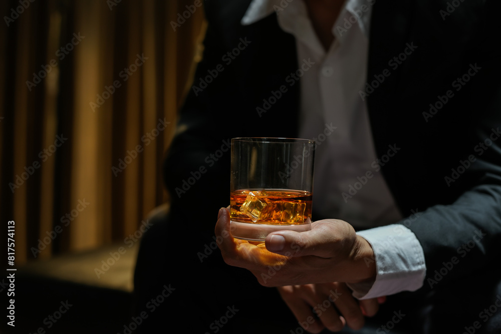 businessmen holding a glass of whiskey businessmen holding a glass of whiskey