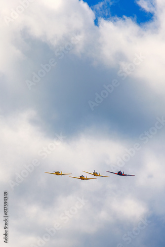 Group of airplanes in formation among the clouds