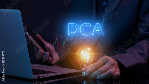DCA, Dollar cost averaging concept. Investment strategy, Regular investment, Saving stock or savings on a monthly, quarterly basis. Businessman holding lightbulb to show DCA icon with investment graph photo
