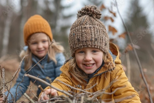 Children exploring the woods and collecting sticks near their campsite