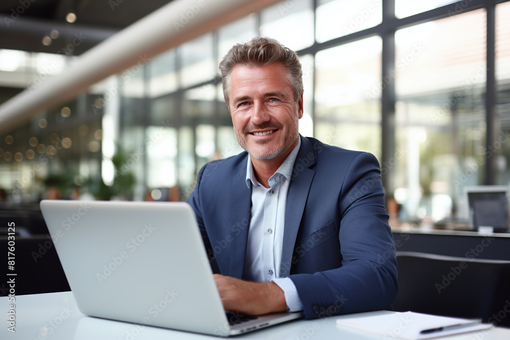 Smiling mature adult business man executive working on laptop. Smiling mature adult business man executive working on laptop.