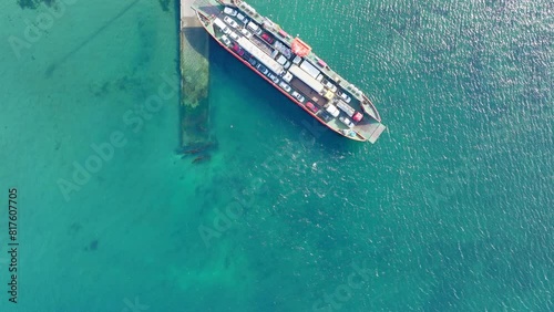 Aerial Bird Eye View Of Ferry Boat Waiting At Big Island of Chiloé, Chile. Slow Dolly forward photo