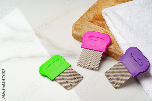 Anti lice combs and towel on white background photo