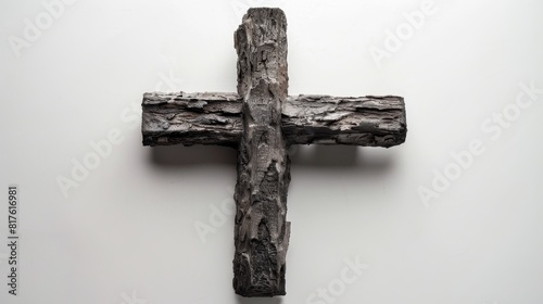 Top view of a Christian cross made of ash, symbolizing sacrifice, perfect for Easter season advertising, isolated with studio lighting