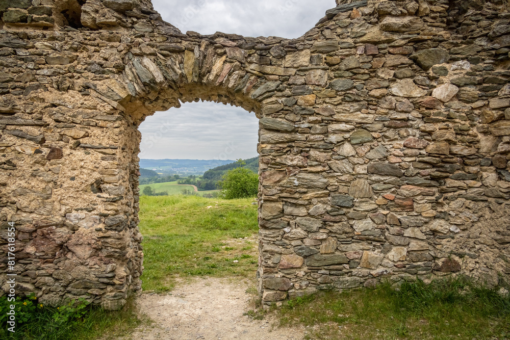 View through stony archway in wall of ruins of medieval castle View through stony archway in wall of ruins of medieval castle