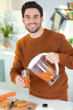 man making healthy juice at home