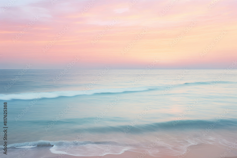 Fototapeta premium The photo shows a beautiful beach scene with a pink and blue sky and soft waves.