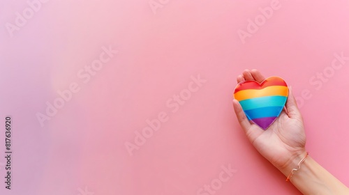 hand holding rainbow heart, blank space, minimalism, negative space, template, pride month lgbtqia theme, pastel background wallpaper photo