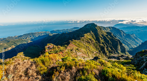 Hiking on the highest peak of Madeira Pico Ruivo next to the cottage Abrigo do Pico Ruivo. Views of the surrounding mountains lanscape during sunny day