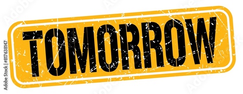 TOMORROW text written on orange-black stamp sign.