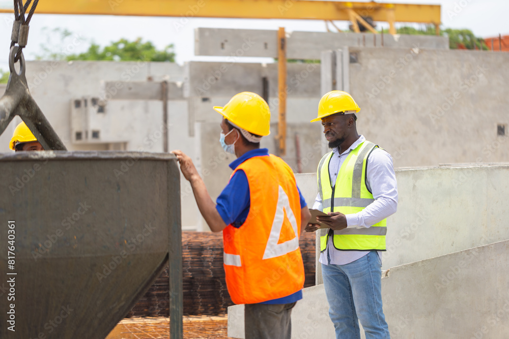 Construction workers at work, Foreman and worker team discussing at precast concrete factory site Construction workers at work, Foreman and worker team discussing at precast concrete factory site