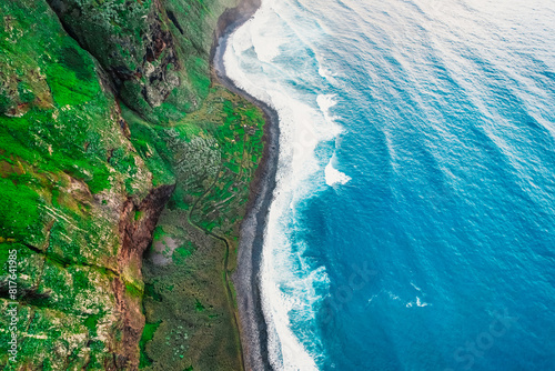 Aerial view of rough blue ocean with waves, volcanic beach in Teleférico das Achadas da Cruz, Madeira, Portugal photo