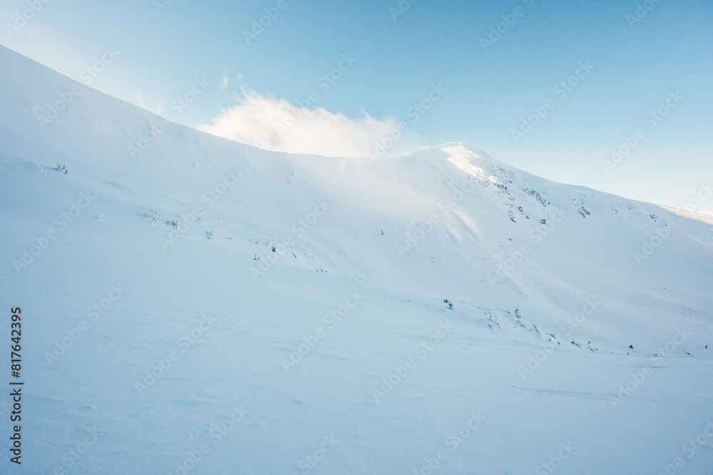 Alpine mountains landscape with white snow and blue sky. Sunset winter in nature. Frosty trees under warm sunlight. Wonderful wintry landscape. Low Tatras, Slovakia