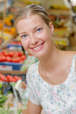 Portrait of smiling lady in greengrocers