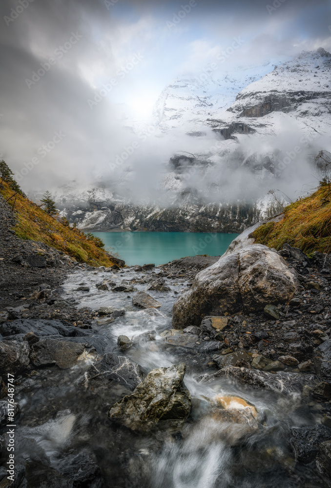 Snowstorm at Sunset over Alpine Stream Flowing into Oeschinensee Snowstorm at Sunset over Alpine Stream Flowing into Oeschinensee