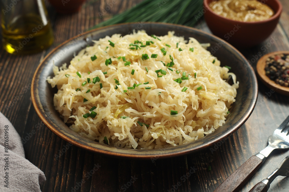 A bowl with traditional German Sauerkraut served in rustic style A bowl with traditional German Sauerkraut served in rustic style
