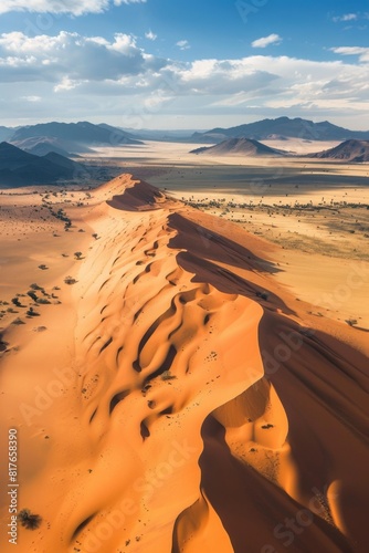 Aerial view of a vast desert landscape  wind-sculpted sand dunes casting long  dramatic shadows