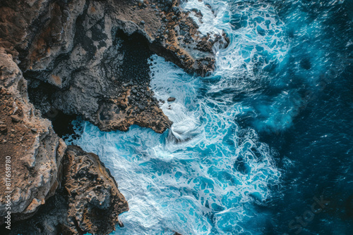 An aerial view of a rocky coastline  with waves crashing against the rugged cliffs  showcasing the contrast between smooth and rough textures. 