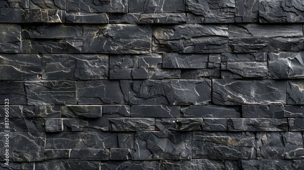 Detailed image showing the intricate patterns and texture of a black stone wall, ideal for a background Detailed image showing the intricate patterns and texture of a black stone wall, ideal for a background