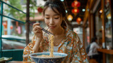 Young Asian Woman Enjoying a Warm Soup in a Cozy Setting