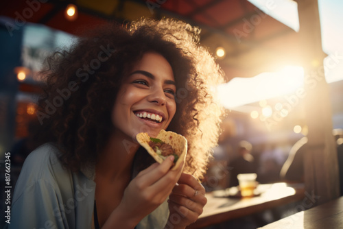 Savoring Flavor: Happy Woman Eating Taco © Natalia Klenova