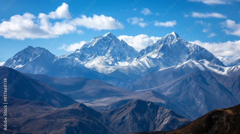Breathtaking panoramic view of majestic snow-capped mountain peaks amidst a rugged alpine terrain. Set against a clear blue sky Breathtaking panoramic view of majestic snow-capped mountain peaks amidst a rugged alpine terrain. Set against a clear blue sky