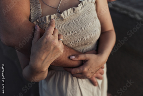 love, honeymoon, dating concept. close up of woman and man embracing on beach