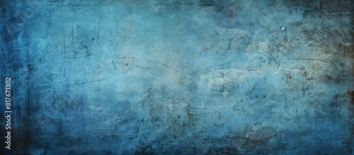 A grungy blue background with a scratched and dotted texture providing ample copy space for images