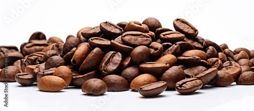 Close up of roasted coffee beans piled on a white background providing ample copy space for text Good morning