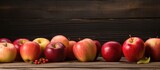 An arrangement of apple fruits is placed on a weathered wooden table with a rustic background as a copy space image