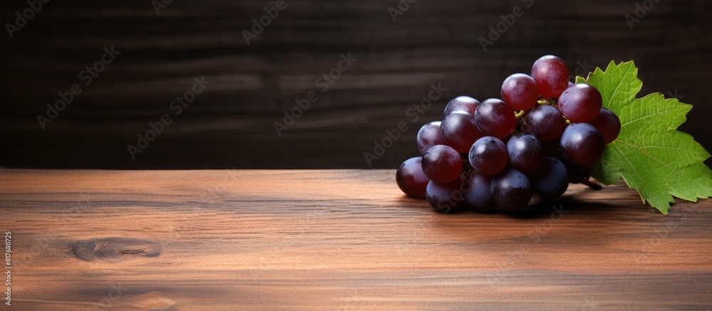 A copy space image of a grape positioned on a background made of wood A copy space image of a grape positioned on a background made of wood