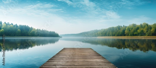 A serene lake with a wooden dock at the end surrounded by a peaceful walkway perfectly captured in this copy space image photo