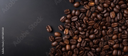 Top view of coffee beans on a dark concrete background providing space for text in the image. Creative banner. Copyspace image