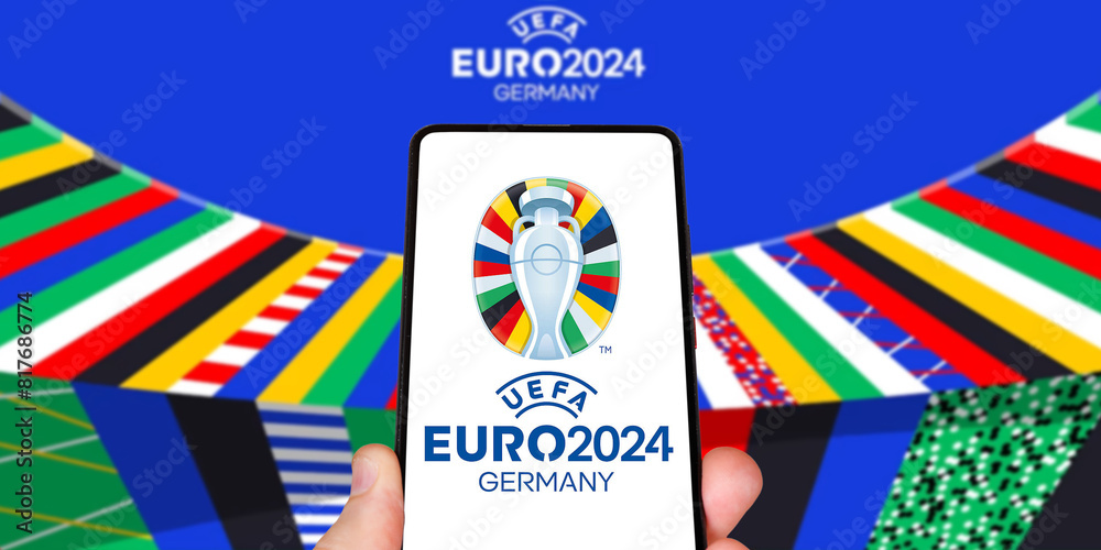 Fototapeta premium UEFA Euro 2024 Germany European Football Championship Europe logo on a mobile photomontage in Germany