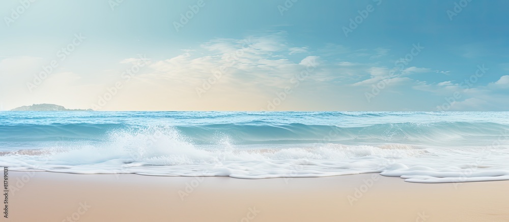 A gentle wave brushes against the sandy shore creating a serene summer background with enough room for a message. Creative banner. Copyspace image