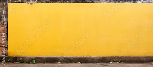 Copy space image of a yellow metal signboard placed against the backdrop of a weathered brick wall